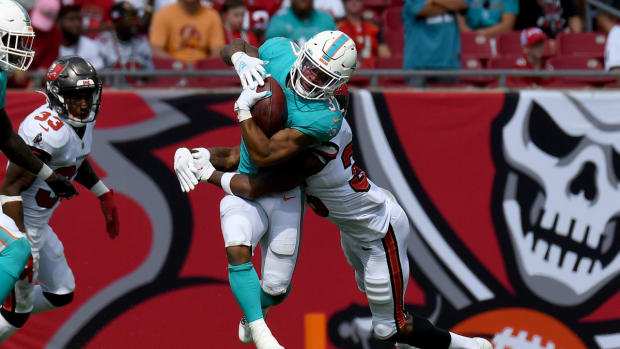 Oct 10, 2021; Tampa, Florida, USA; Miami Dolphins running back Myles Gaskin (37) attempts to get past Tampa Bay Buccaneers defensive back Jamel Dean (35) in the second half at Raymond James Stadium. Mandatory Credit: Jonathan Dyer-USA TODAY Sports